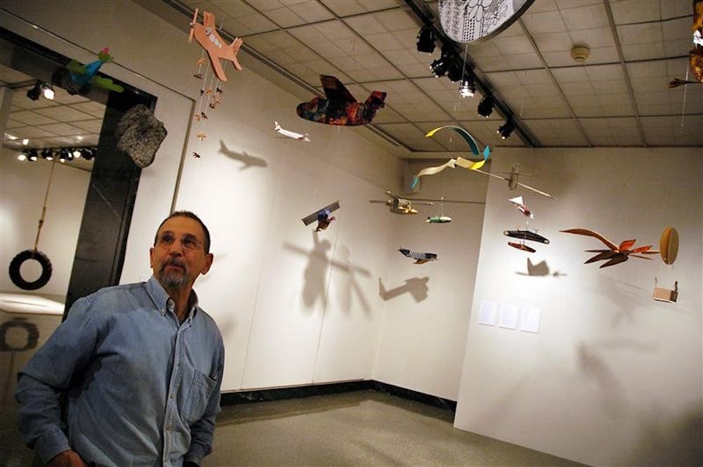 Professor Edward Bernstein, co-head of the IU Printmaking Department, surveys "No Danger," an airplane exhibit Monday at the SoFA Gallery. Bernstein, the co-curator, organized the exhibit with Franco Vecchiet of Italy. The exhibit focuses on positive aspects of travel rather than the negative connotations often associated with flying in the post-9/11 world. "No Danger" is open Tuesday through Jan. 24.