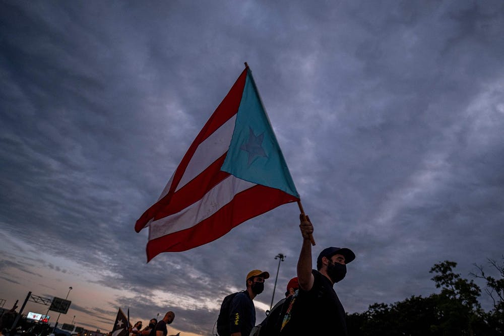 <p>A man holding a Puerto Rican flag is pictured Oct. 15, 2021, in San Juan, Puerto Rico. </p>