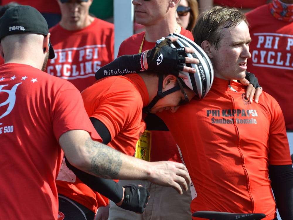 Andrew La Valle is consoled by a teammate after finishing eighth in the 2019 men’s Little 500 on April 13, 2019, at Bill Armstrong Stadium.