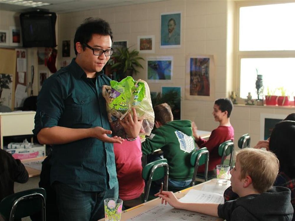 David Chen asks a student to repeat a phrase in Chinese during his class on December 9. Chen rewarded every student with a piece of candy after they had pronounced the phrase correctly.