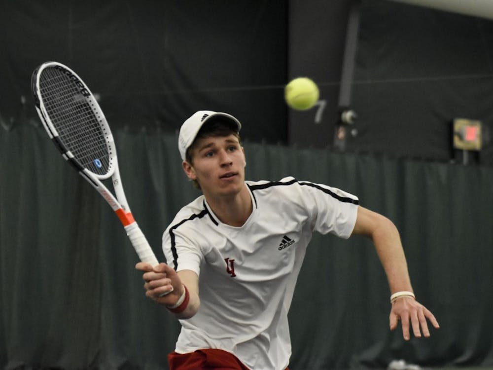 Sophomore Bennett Crane reaches for a forehand during his 6-2, 6-7, 4-6 singles loss against Wisconsin. IU will play Wisconsin-on April 5 in Madison, Wisconsin. 