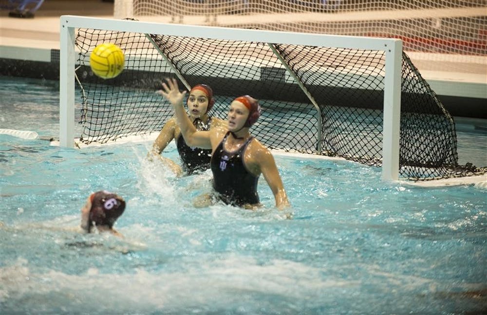 Freshman Goalie Jessica Gaudreault and Junior Attacker Shae Fournier block a shot together during their game against Long Beach State on Feb. 23, 2013, at the Counsilman-Billingsly Aquatic Center. The IU Women's Water Polo team lost the game 7-4 during the weekend-long Fluid Four tournament.