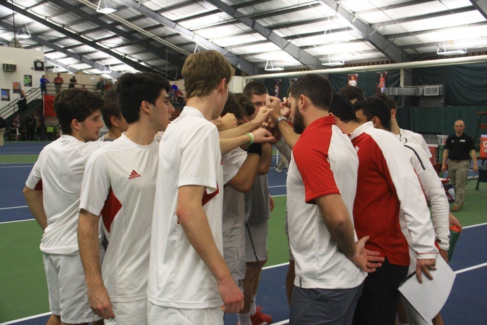 <p>The IU men's tennis team gathers in a circle with coaches before a singles match against Purdue at the IU Tennis Center in April of 2017. IU split their two matches at the ITA Kickoff Weekend.</p>