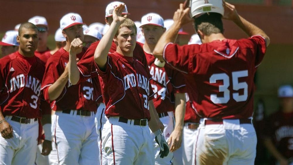 Junior Jerrud Sabourin is greeted by his teammates during the Hoosiers' 21-12 win against the Iowa Hawkeyes on Sunday at Sembower Field.