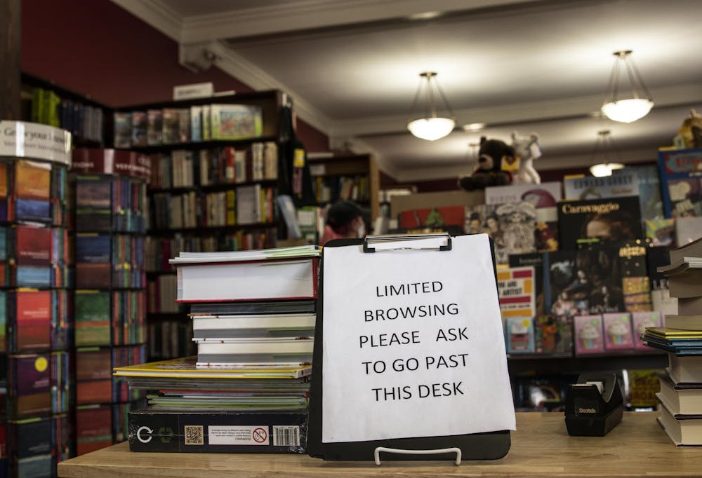 <p>A sign reads, “Limited browsing. Please ask to go past desk,” on July 23 at the Book Corner bookstore. New rules have been put in place for book shoppers during the pandemic, including the addition of curbside ordering.</p>