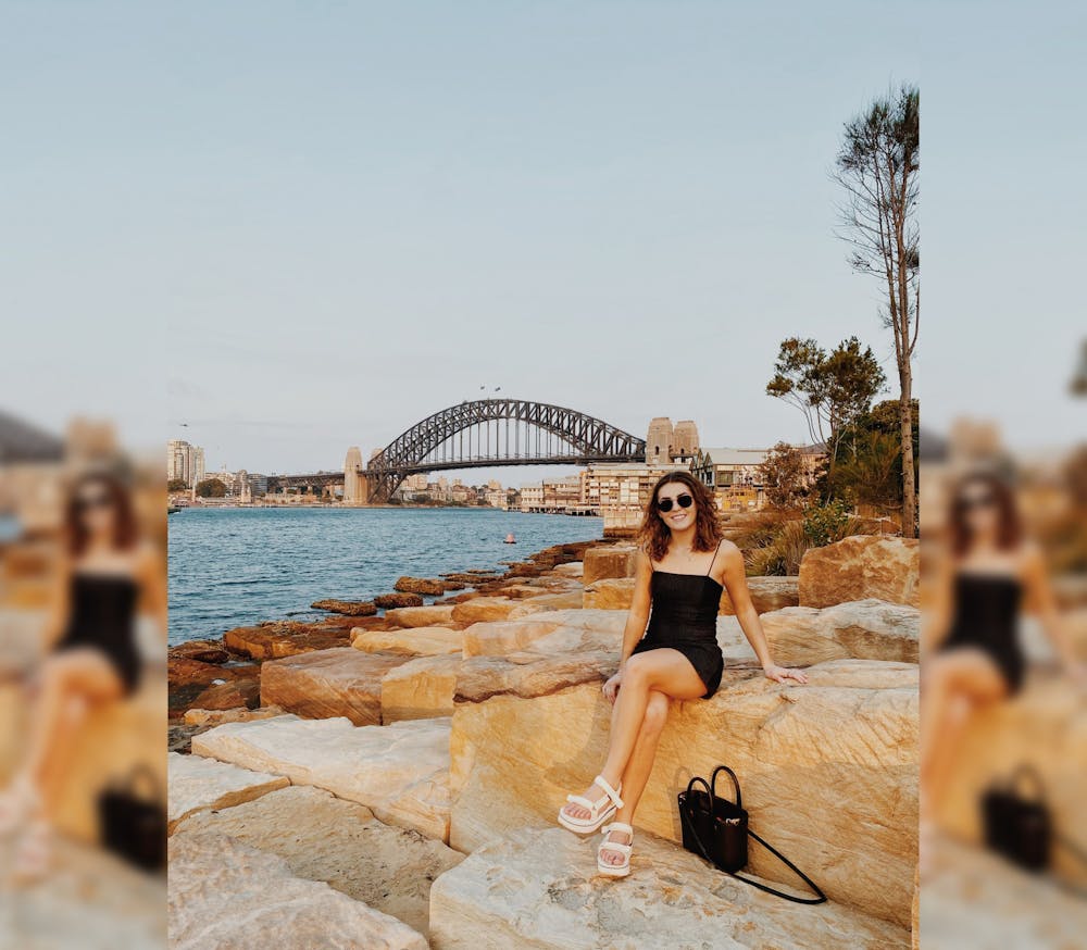 <p>Junior Sydney Tomlinson sits on a rock Jan. 3 outside Sydney Harbour. Tomlinson is studying in Sydney, Australia, this spring.</p>