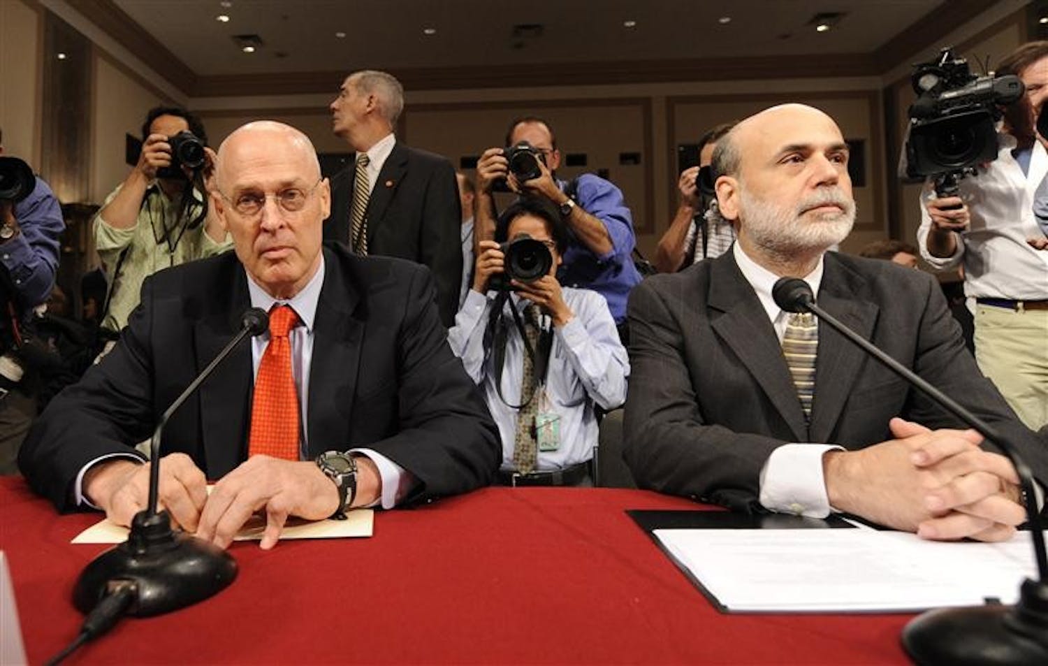 Federal Reserve Chairman Ben Bernanke, right, and Treasury Secretary Henry Paulson, sit at the witness table prior to testifying before the Senate Banking Committee on Tuesday at Capitol Hill in Washington.