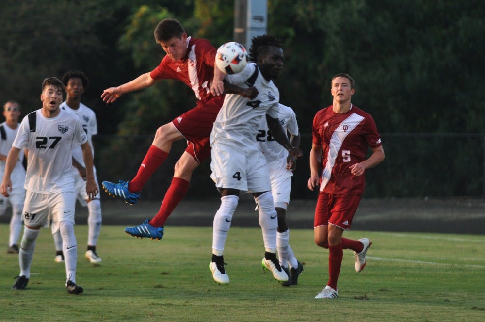 Sophomore midfielder Trevor Swartz collides in mid-air with an Oakland player during IU's exhibition game on Thursday evening.