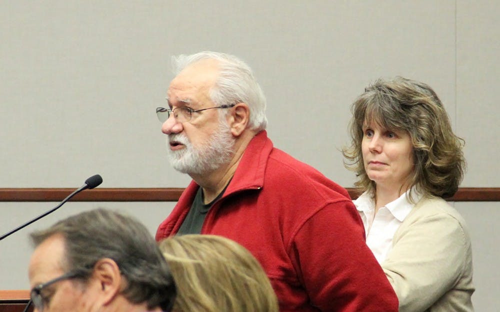 Ron Chatlos (left) and Cindy Rhodenbaugh bring up an issue of leaking pipes at their properties to the City Council on Wednesday.