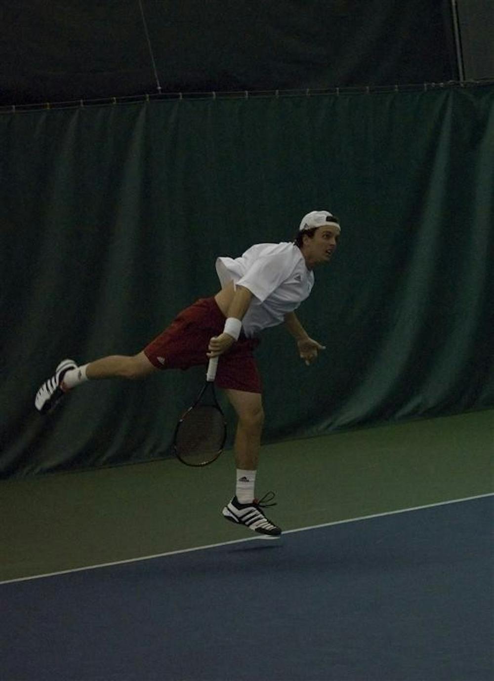 Sophomore Lachlan Ferguson completes a serve during a singles match against Eastern Kentucky University January 17, 2009.