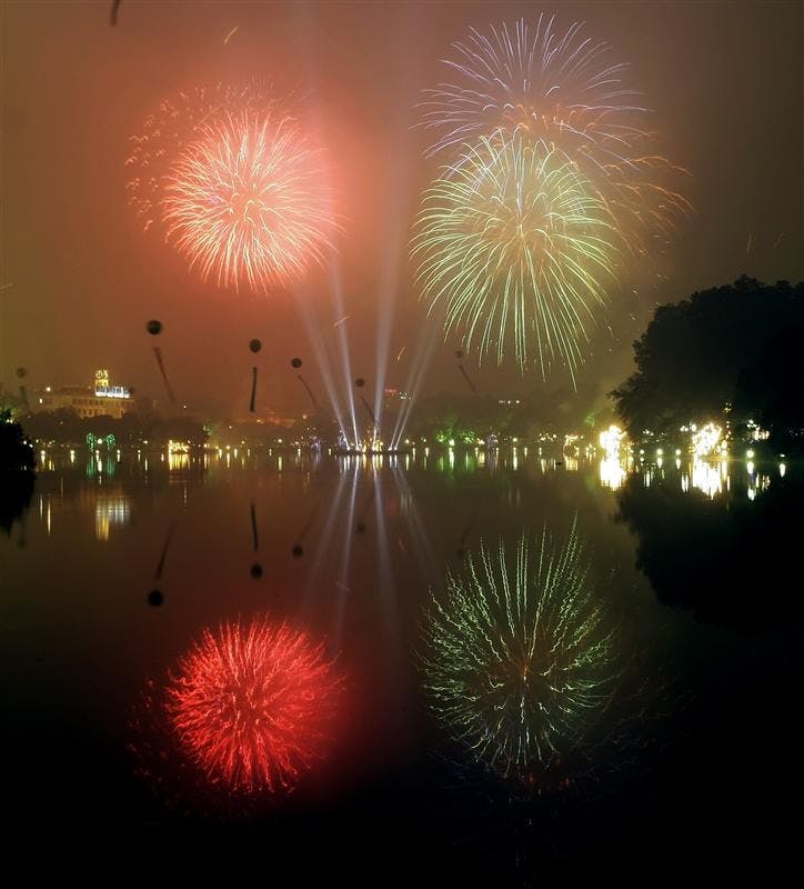 Fireworks are launched above Hoan Kiem Lake Monday in Hanoi, Vietnam, Monday for the Lunar New Year celebrations.