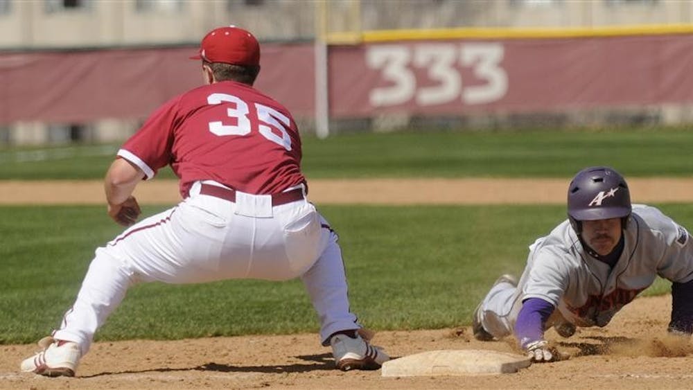 Senior infielder Jerrud Sabourin tries to catch Evansville's Ryan Oesterle in a tag-up during the first of two games against Evansville on March 27 at Sembower Field.