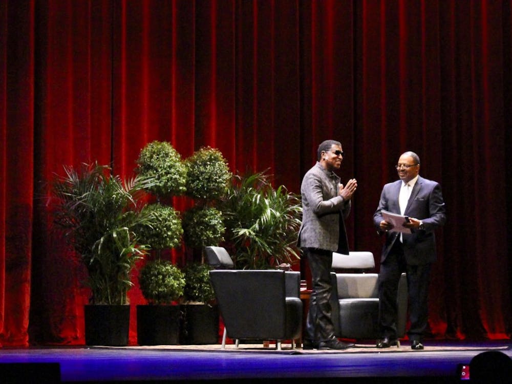 Kenneth "Babyface" Edmonds stands alongside James A. Strong as attendees welcome him to a Q&amp;A. Edmonds received an honorary doctoral degree from IU.&nbsp;