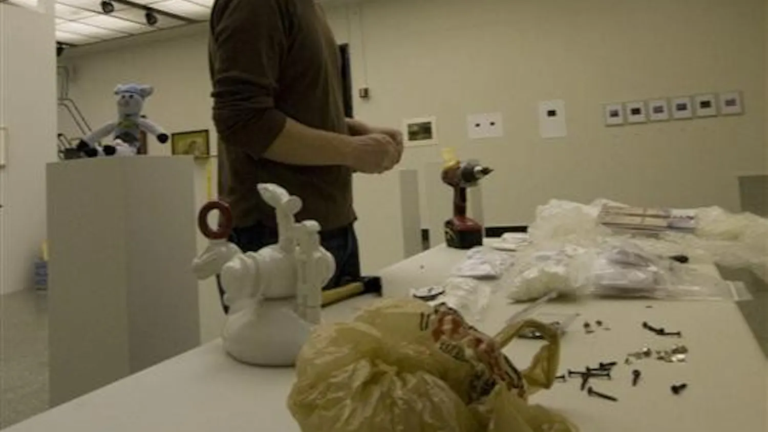 Fine Arts installation staff member Tyson Skross chooses what pieces he should next place in preparation for the SoFA Gallery Holiday Art Sale. The gallery opens to the public today, while bidding and buying will commence on Friday.