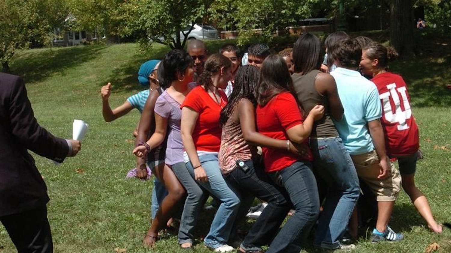 Hudson-Holland Scholars try to sit down and stand back up in a seated circle Wednesday in Dunn Meadow. The students also played ‘Never have I ever,’ came up with dances and performed them for each other.