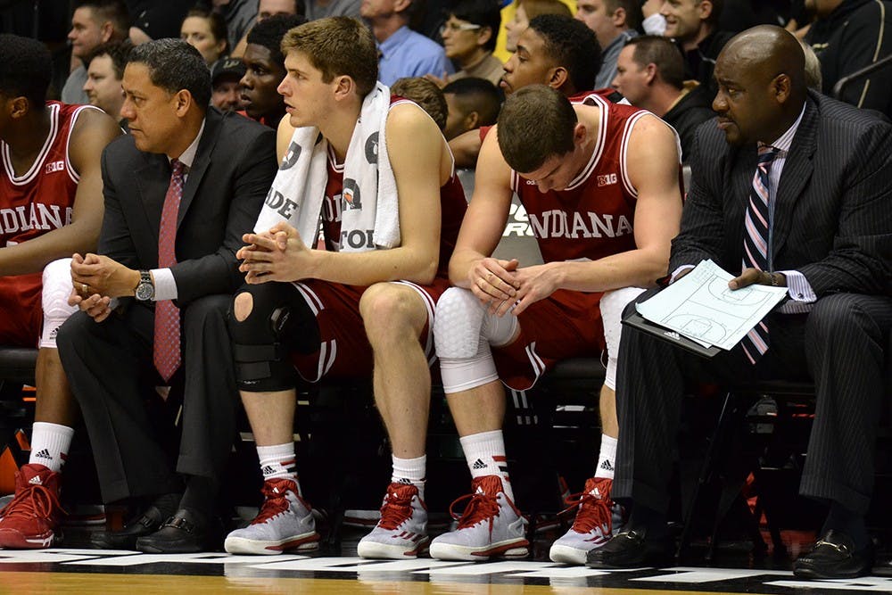 Junior guard Nick Zeisloft sits on the bench after he fouls out during the game against Purdue Wednesday night at Mackey Arena.