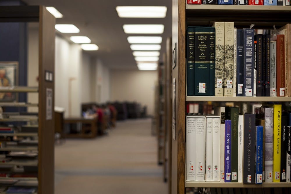 <p>Books sit on a shelf April 22 in the Herman B Wells Library. Senior Rachel Cogen is writing a book about her experiences playing football.</p>