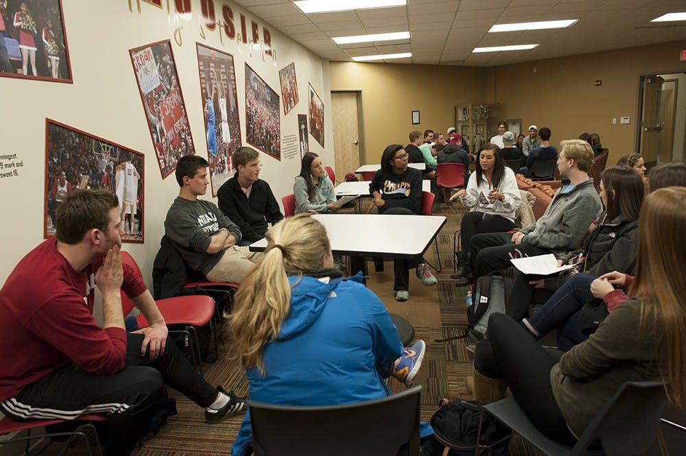 Chantel Borg (in white), a member in Delta Gamma, shares with her informal group. There were over 200 students from different sororities and fraternities present on Tuesday evening at the Briscoe Residence Hall to discuss different matters including sexual assault.