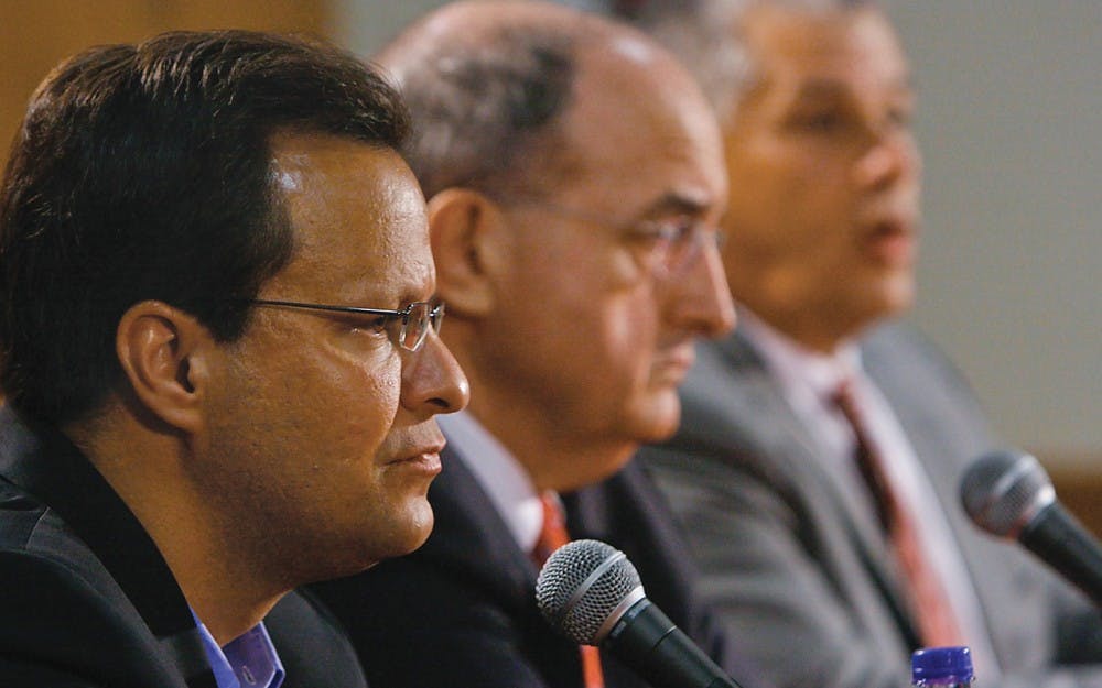 Chris Pickrell • IDSIU head basketball coach Tom Crean and IU president Michael McRobbie sit while IU Athletic Director Rick Greenspan speaks to the press Friday, June 6, 2008 