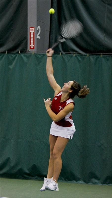 Freshman Megan Matter serves the ball during doubles matchplay against Ball State Sunday afternoon at the IU Tennis Center.