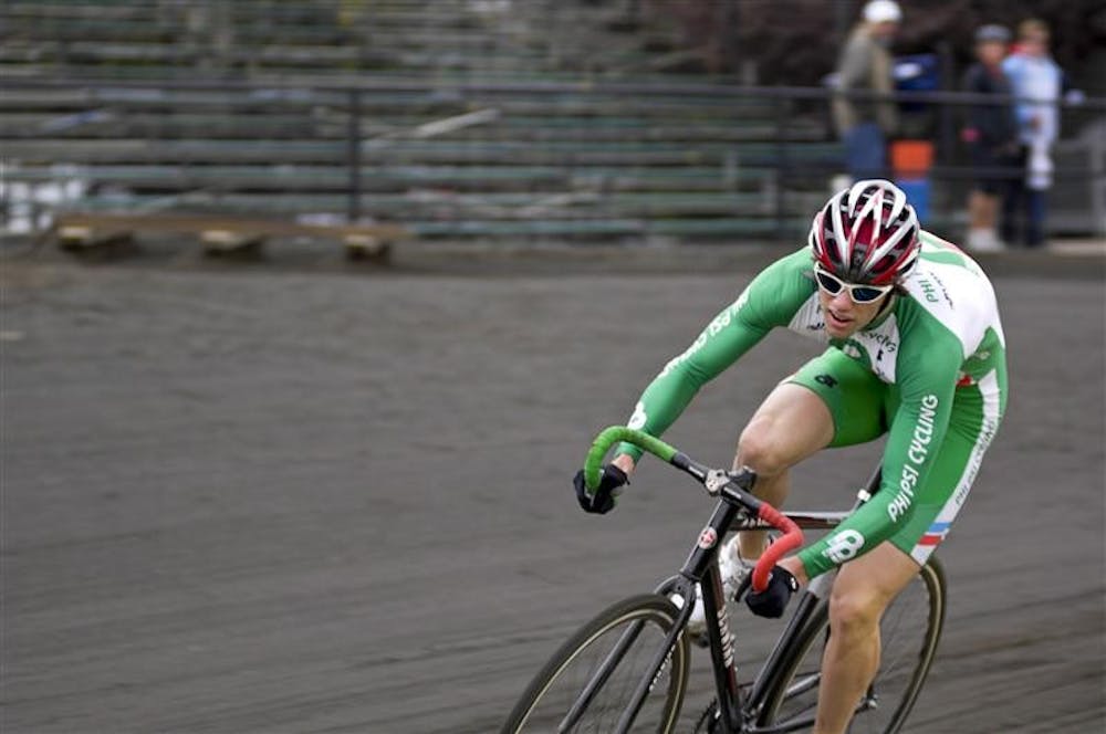 Adam Mercer of the Phi Psi Cycling team rounds corner three during qualifications Saturday at Bill Armstrong Stadium.