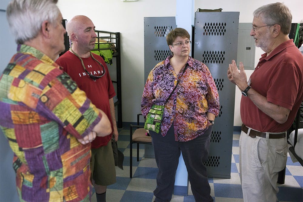 Dick Rose and Alan Backler, far left and far right and Board Members at the Shalom Community Center, give a tour of Friend's Place shelter during the Shalom Community Center open house hosted to introduce the shelter to the public Sunday afternoon.  Geoff McKim, center-left and member of the Monroe County Council, and Jean Capler, center-right and advocate for transgender rights in the Shalom Community Center, are both residents who hope that the transition to the new shelter will help shelter and rehabilitate those looking for residence in the future, they say.