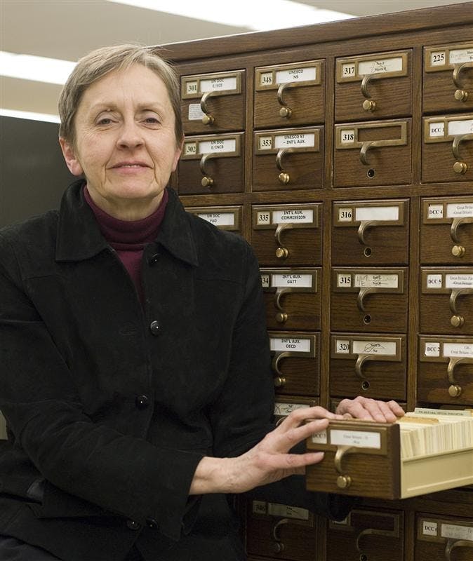 IU librarian Lou Malcomb displays the file card form of the Dewey Decimal System, which since the early 1990s has been translated to the internet. Ms. Malcomb, who has now worked in IU libraries for nearly four decades, specializes in government documents.