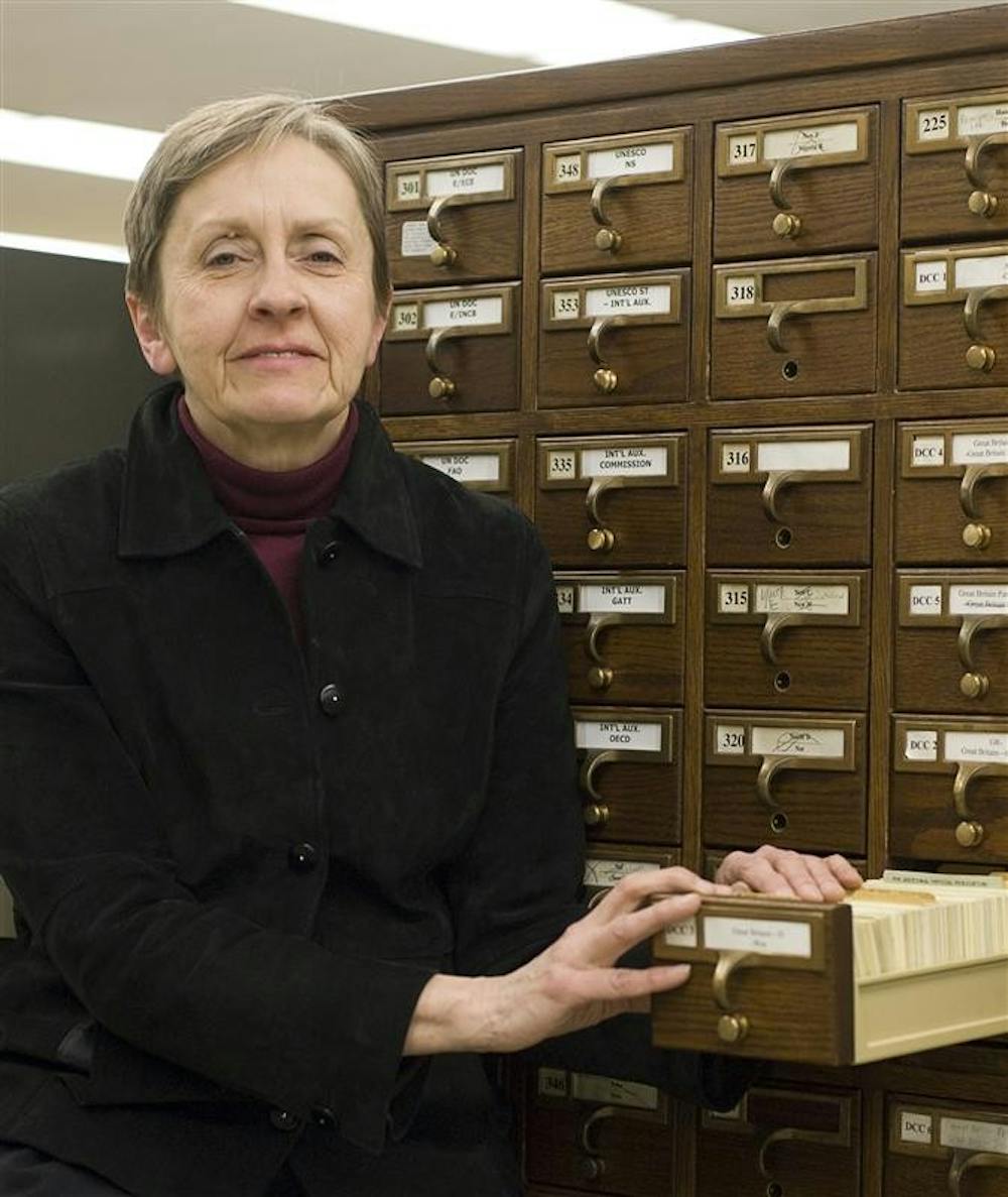 IU librarian Lou Malcomb displays the file card form of the Dewey Decimal System, which since the early 1990s has been translated to the internet. Ms. Malcomb, who has now worked in IU libraries for nearly four decades, specializes in government documents.