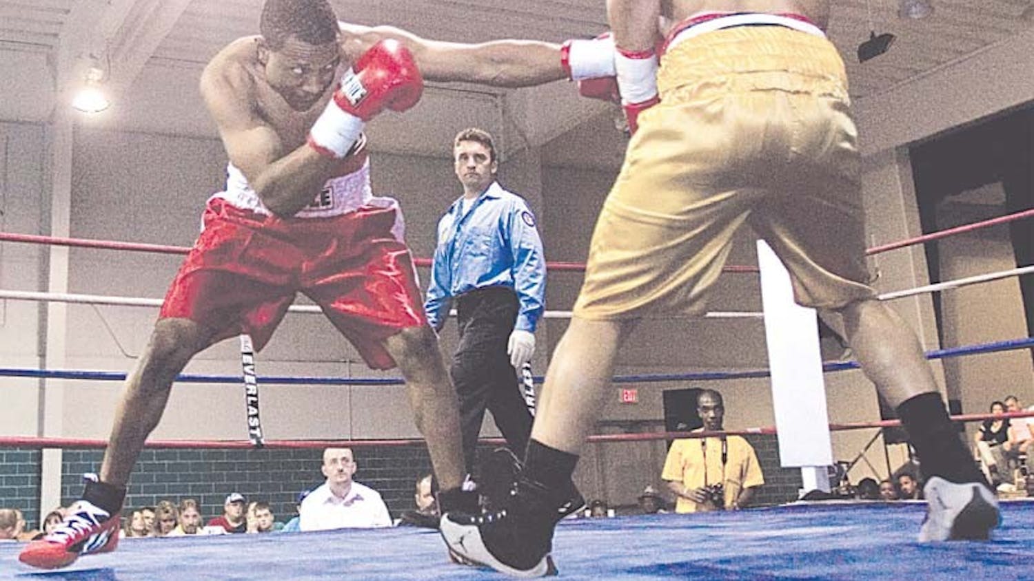Abdul Blackburn punches Louis Brown as referee Eric Fetzer watches. Blackburn was defeated by Brown in the six-round bout.