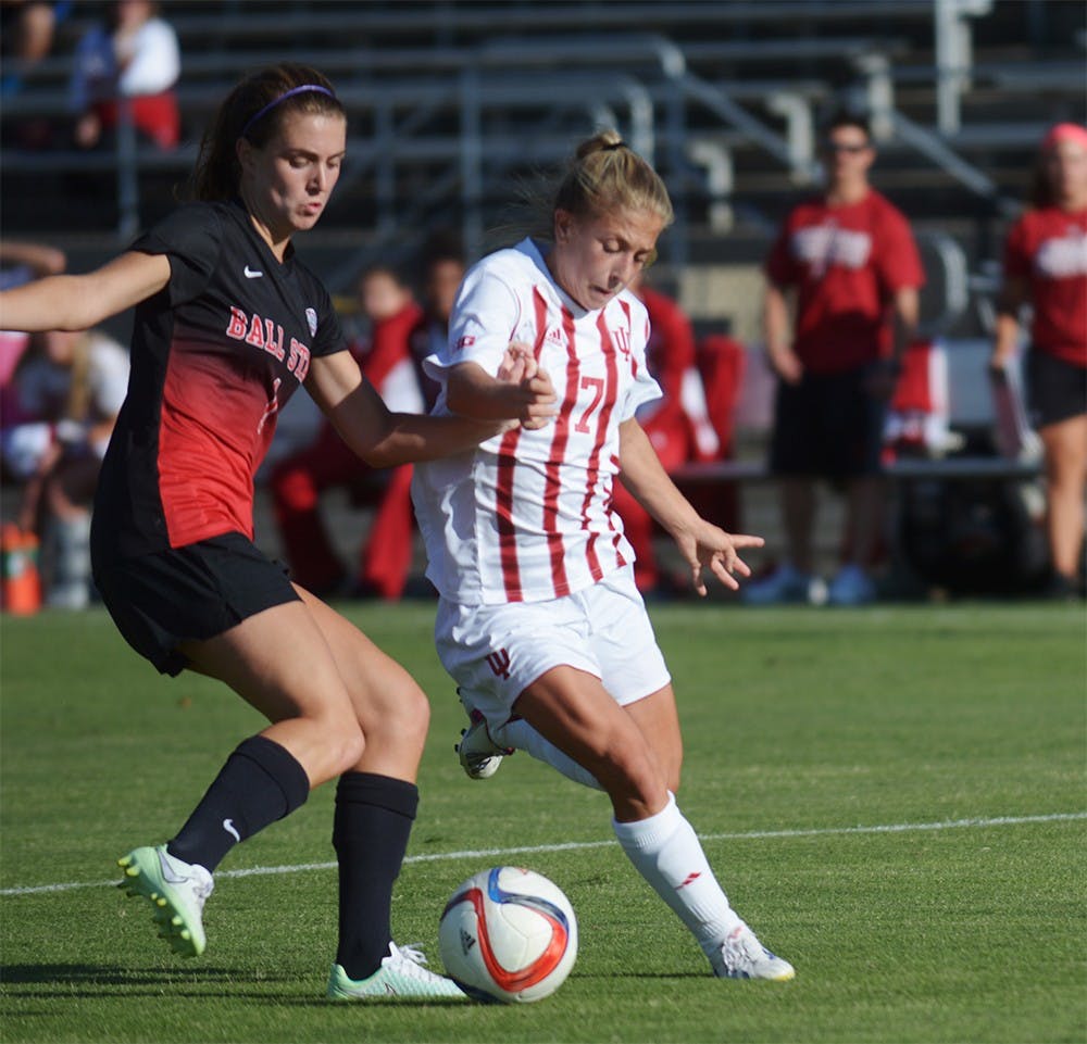 Sophomore Midfielder Kayla Smith holds off a Ball State University Cardinals' defender at Bill Armstrong stadium on Sunday evening. IU tied the game 1-1.