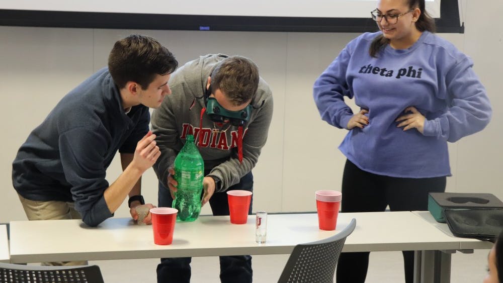 Students Tom Sweeny and Drew Ficociello lead an activity about alcohol consumption and the dangers that come along with it during the callout meeting for Culture of Care. The activity was put in place to help the audience understand what their goals are as a club. &nbsp;
