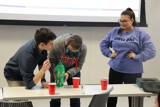 Students Tom Sweeny and Drew Ficociello lead an activity about alcohol consumption and the dangers that come along with it during the callout meeting for Culture of Care. The activity was put in place to help the audience understand what their goals are as a club. &nbsp;