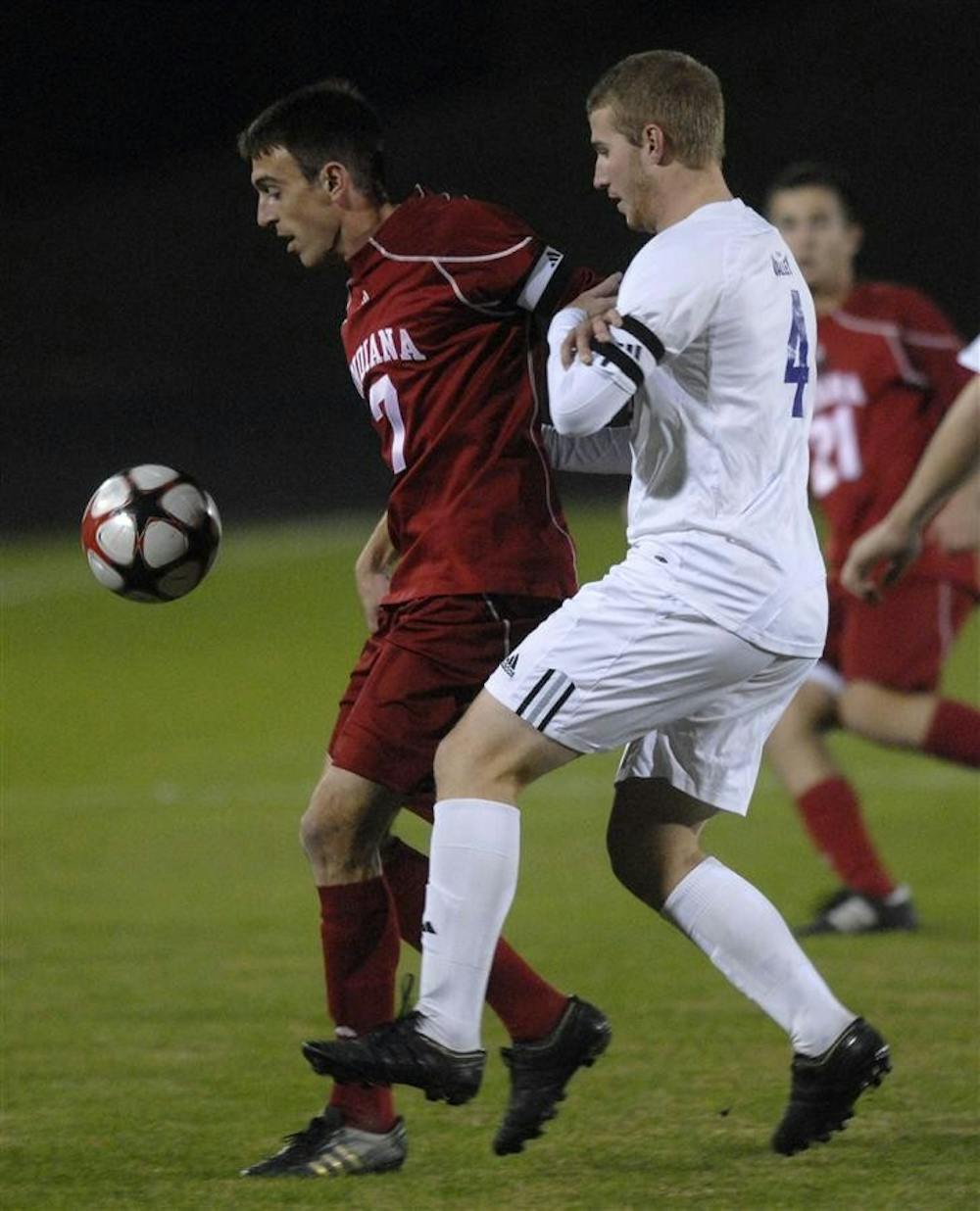 Senior midfielder Eric Alexander protects the ball from Evansville's Dan Gibson during the first half of the Hoosier's game against the Purple Aces Wednesday evening at Bill Armstrong Stadium. Both teams remain scoreless ten minutes into the second half.