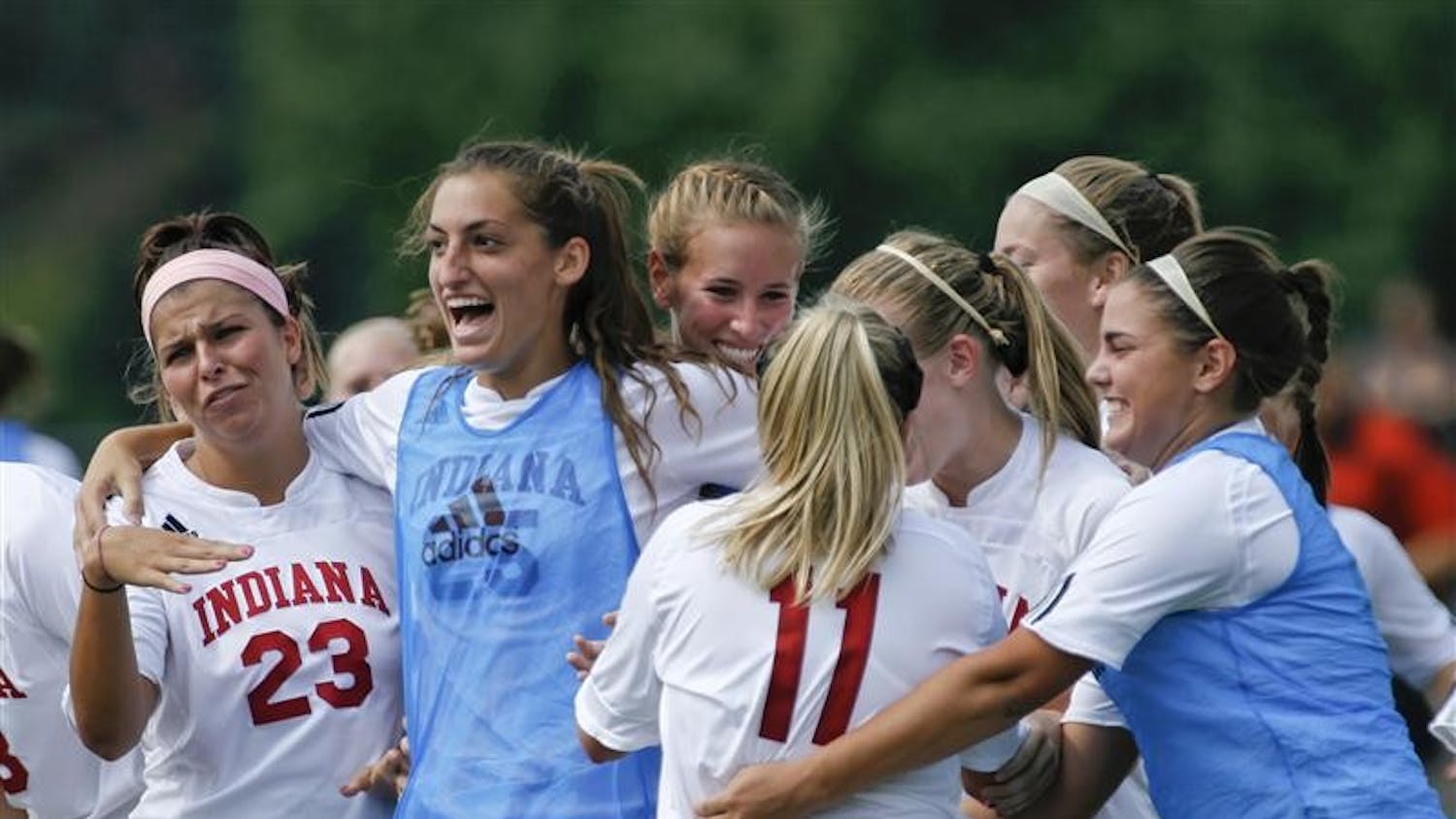 The IU womens soccer team celebrates with junior forward Kristin Arnold (11) following Arnold's goal-winning kick against Loyola Sunday afternoon at Bill Armstrong Stadium.