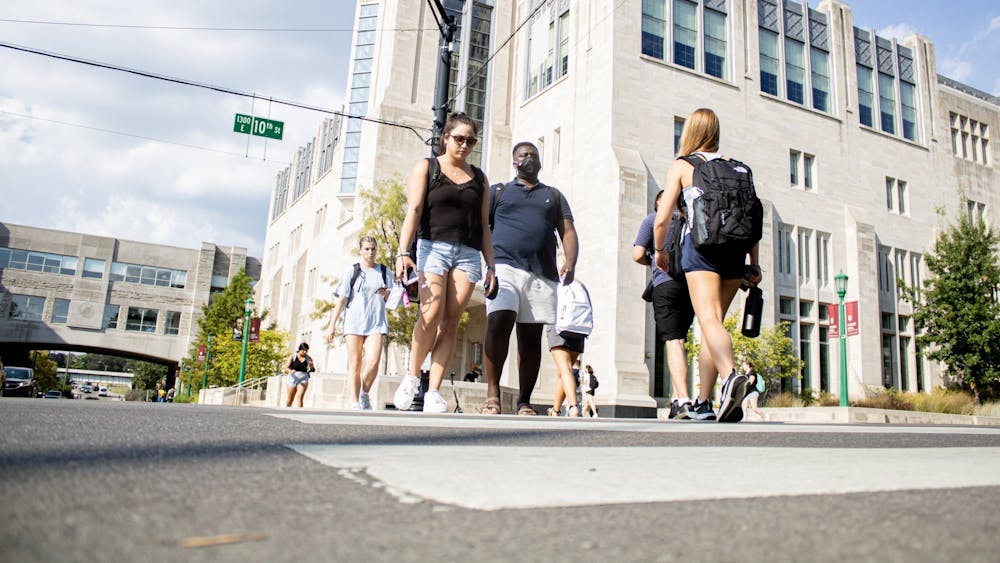Students cross the street Aug. 24, 2021, at the corner of North Fee Lane and East 10th Street.