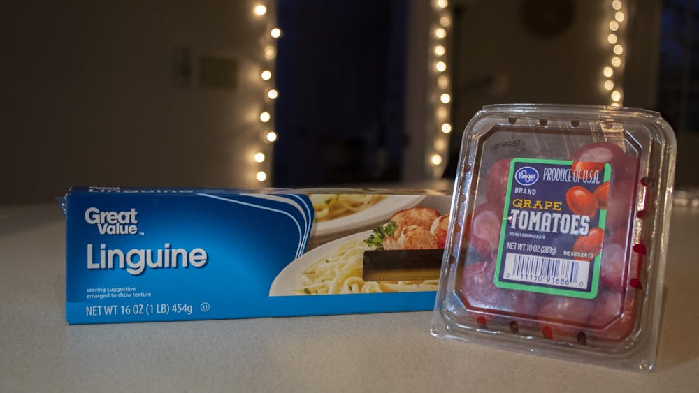 A box of linguine pasta and a package of grape tomatoes sits on the counter of an off-campus apartment in Bloomington. 