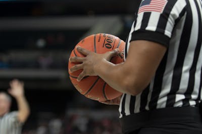 A referee holds a basketball at the Big Ten Tournament on March 6 at Bankers Life Fieldhouse in Indianapolis. The NCAA announced Monday the 2021 men&#x27;s basketball tournament will be held at one geographic location, with the state of Indiana and the Indianapolis metropolitan area being the likely location.