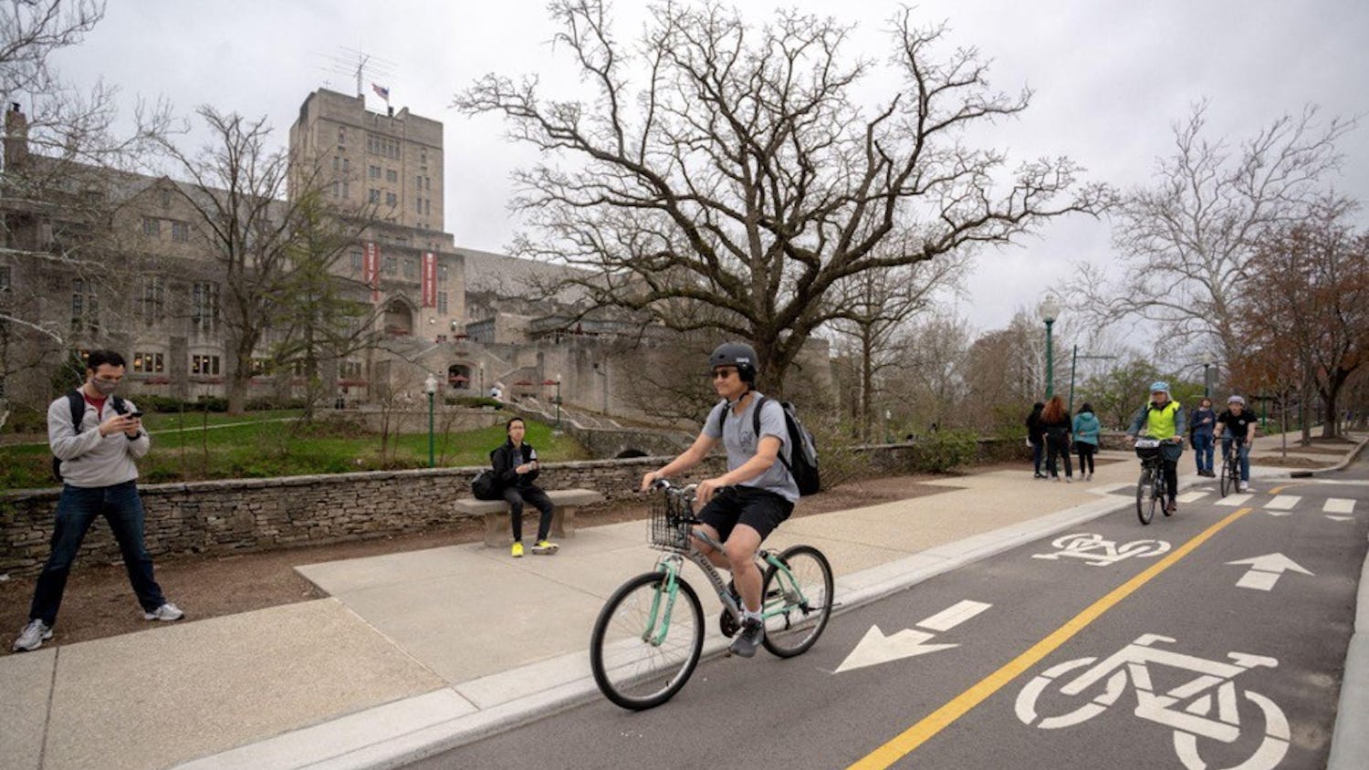A bicyclist rides down a bike lane outside of the Indiana Memorial Union.