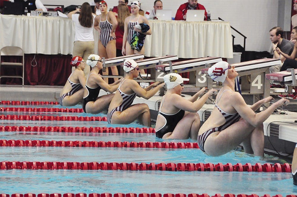Swimmers from IU and Purdue take their mark during the womens 100 yard backstroke on Satuday. IU Sophomore backstoker Marie Chamberlain won the event with a time of 55.00 seconds. Both the men and women swept Purdue at their last home meet of the season with the men winning 187-107 and the women 185.5-114.5.