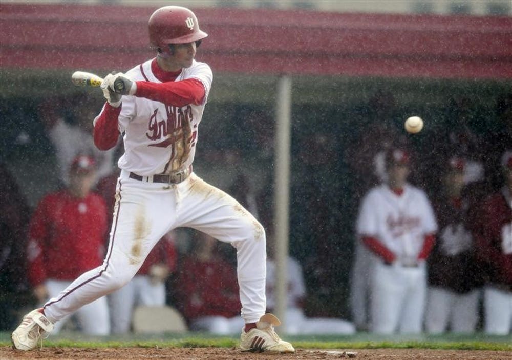 IU freshman Vince Gonzalez stares down a pitch during a game against Louisville as the rain pours Tuesday at Sembower Field.