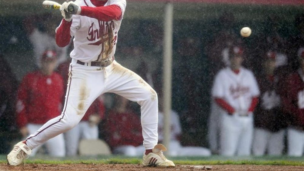 IU freshman Vince Gonzalez stares down a pitch during a game against Louisville as the rain pours Tuesday at Sembower Field.