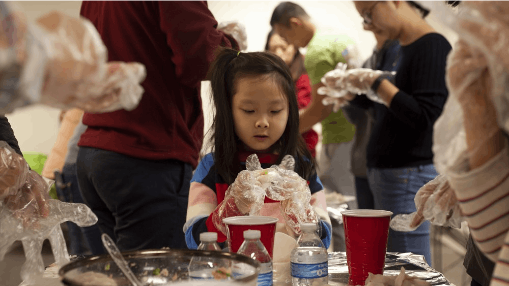 Younjei Choe, 7, celebrates her birthday by making dumplings with her family Feb. 2 at Campus View Apartments. After Choe made each dumpling, she would show her mom before working on the next one.&nbsp;