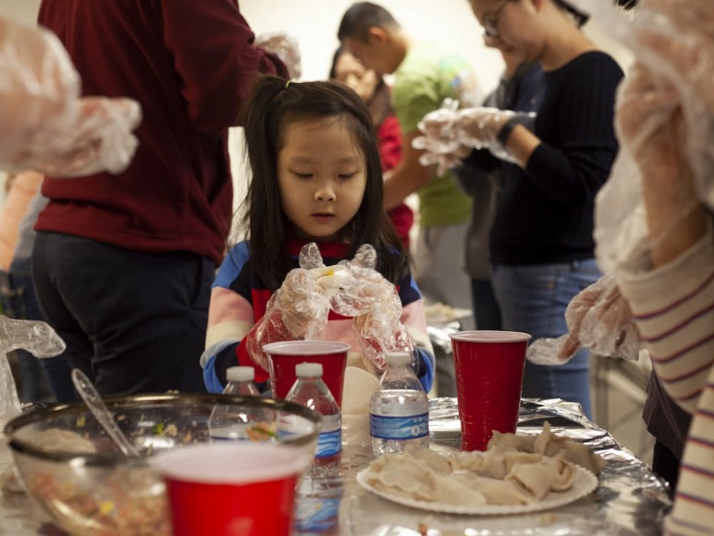 Younjei Choe, 7, celebrates her birthday by making dumplings with her family Feb. 2 at Campus View Apartments. After Choe made each dumpling, she would show her mom before working on the next one.&nbsp;