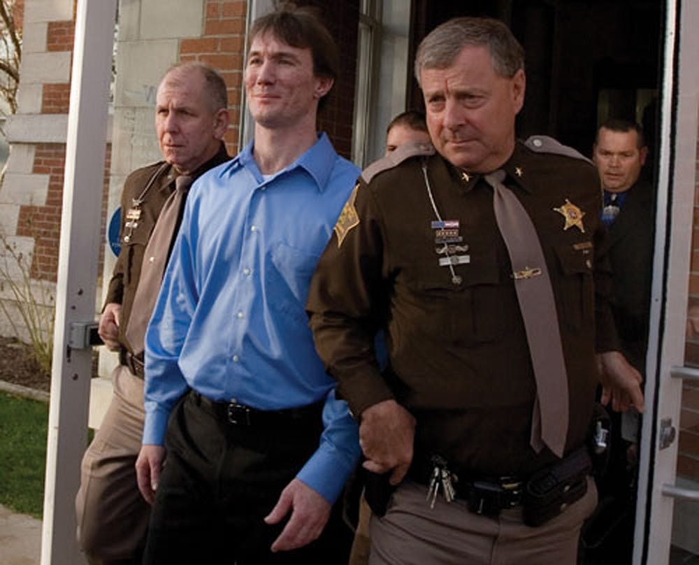 Police escort John R. Myers II from the Morgan County Courthouse October 30, 2006 after a jury found him guilty of the 2000 murder of IU sophomore Jill Behrman.  