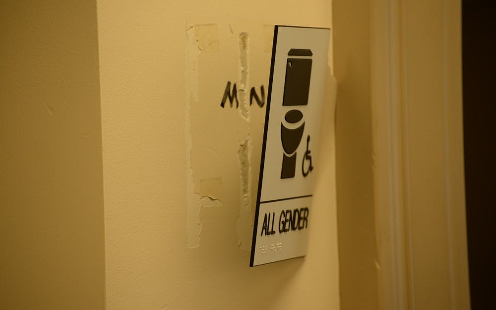 A gender-neutral bathroom sign on the third floor of the Student Building was ripped partially from the wall Tuesday.