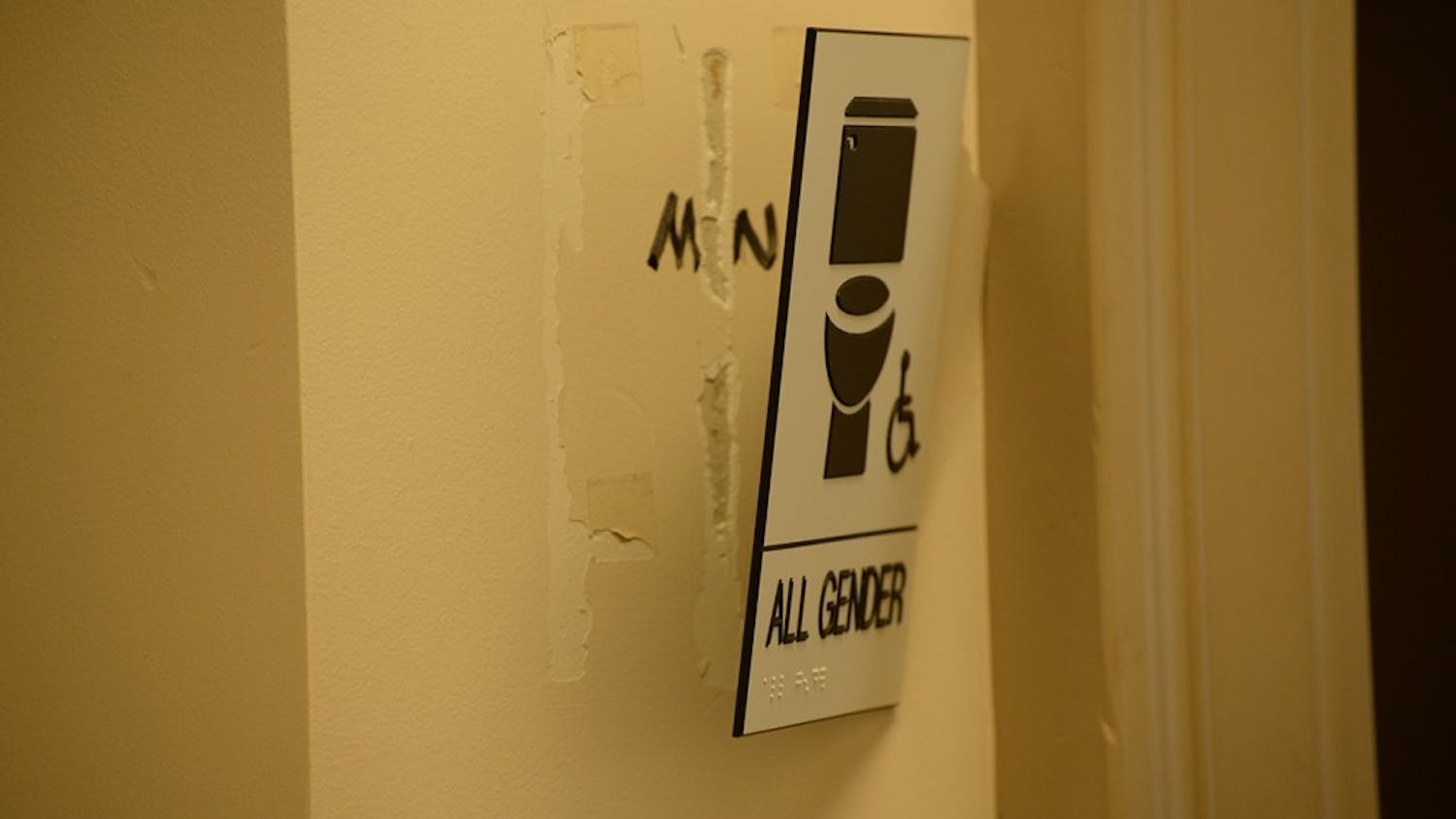 A gender-neutral bathroom sign on the third floor of the Student Building was ripped partially from the wall Tuesday.