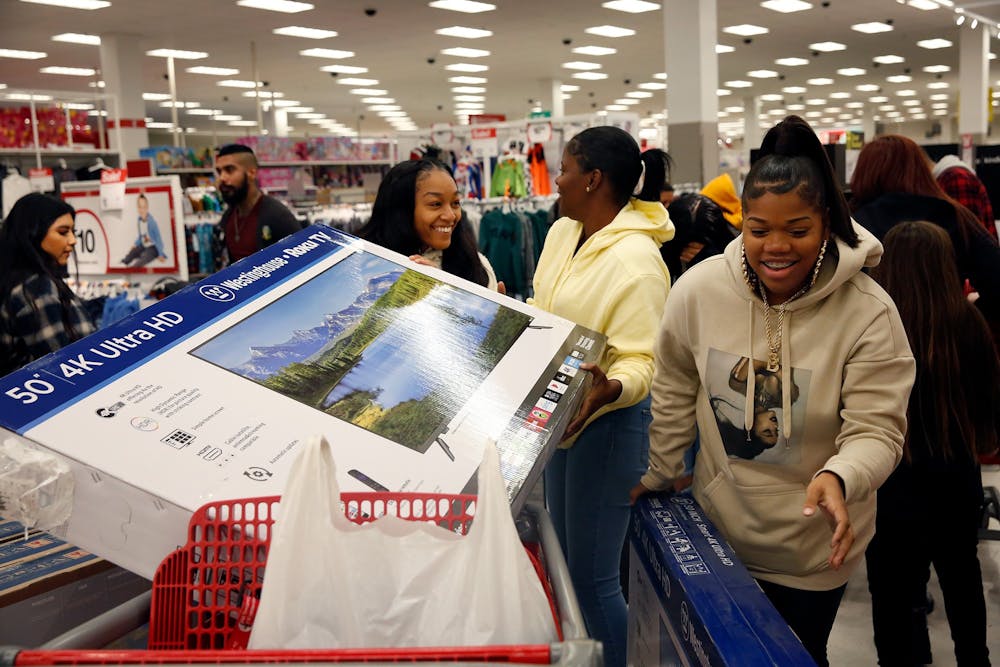 Shoppers Brittney McFaddenn, Rayneisha Yancey and Ja'shay Stagg bring a new television in their cart during Black Friday shopping Nov. 29 at Target in Carson, California. 