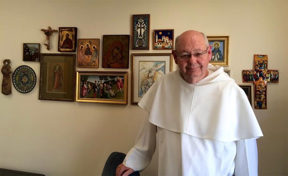 Father John Meany in his office at St. Paul Catholic Center. In the four days since the Pope released his newest document, the pastor has tried to discern what messages to take away. 