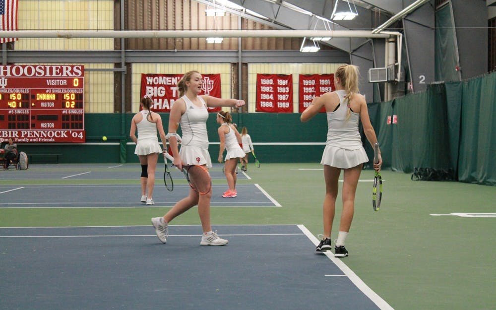 Senior&nbsp;Kim Schmider and sophomore&nbsp;Madison Appel celebrate after scoring a point in a doubles match against Washington State in January. The duo will take on a pair of ranked doubles teams this weekend.