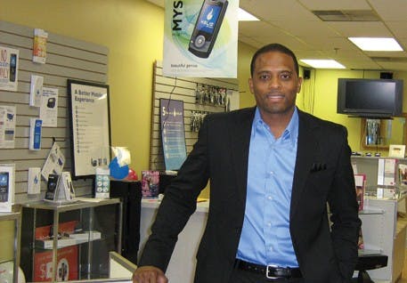 COURTESY PHOTOIU alumnus Shane Hogan stands inside the only T-Mobile cell phone store in Bloomington. Hogan opened the store after he had a jewelery kiosk in the College Mall.
